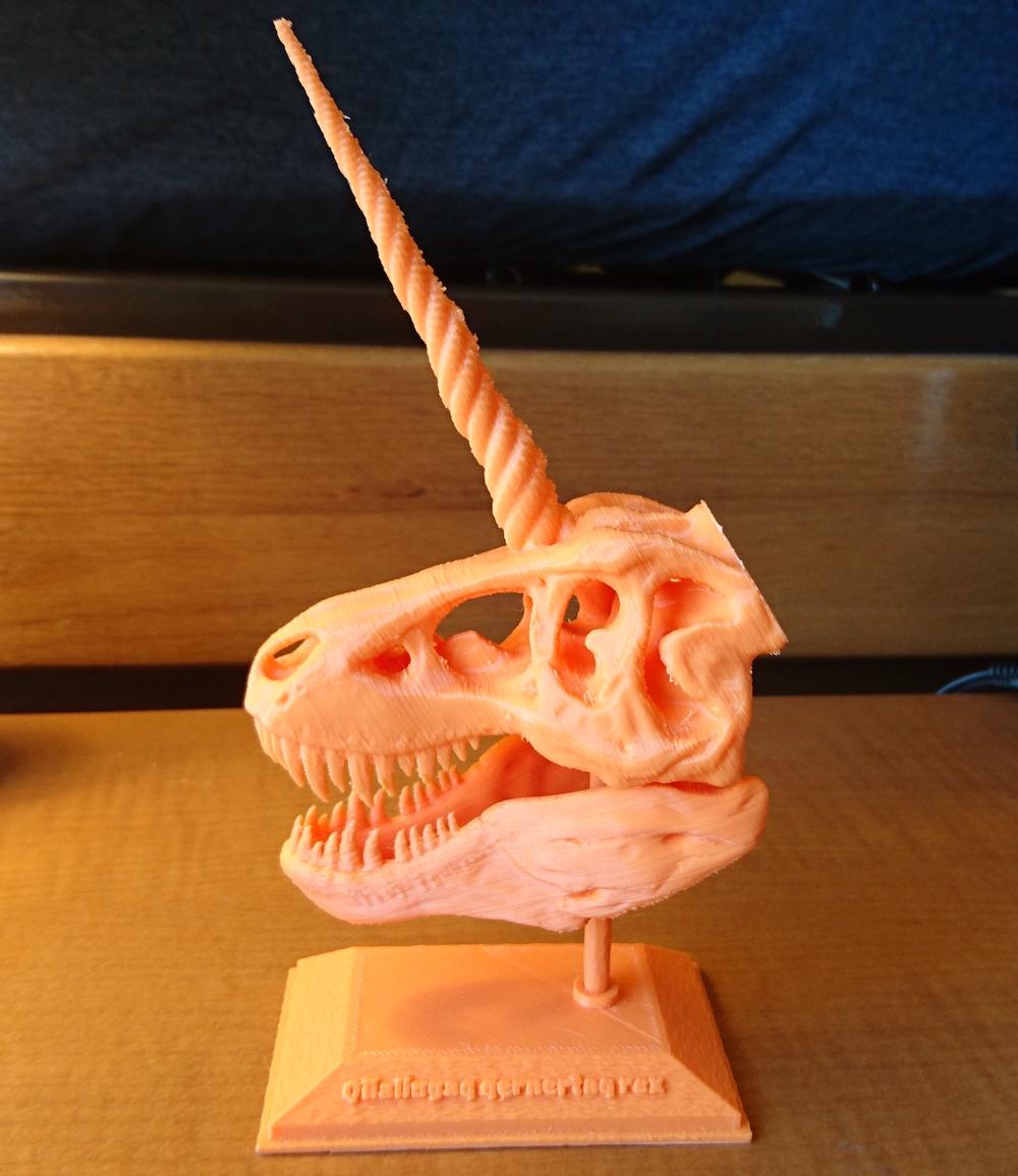 "A 3D printed statue of a T-rex skill with a unicorn horn