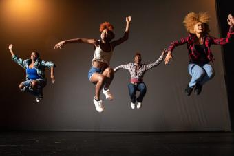 Dance students jumping and dancing in the air