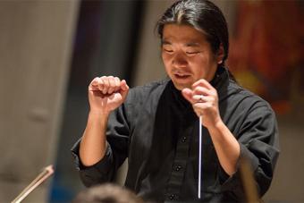 Yutaka Kono looking down at his conductor's table