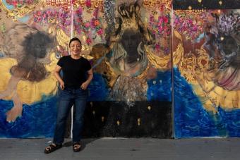 image of woman in front of large painting