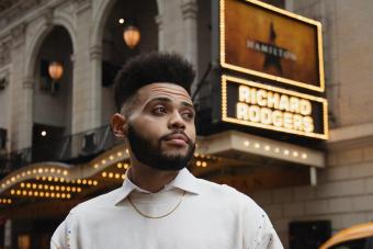 Trey Curtis stands in front of the HAMILTON marquee at the Richard Rodgers Theatre on Broadway
