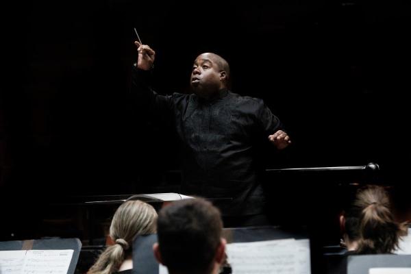 Clifford Croomes conducts from the podium in Bates Recital Hall 