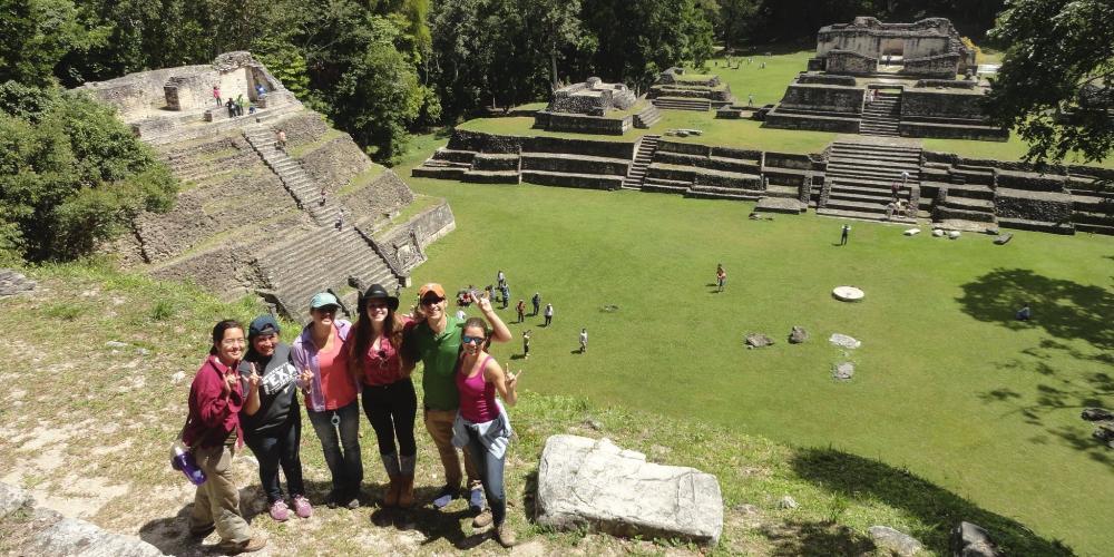 Study abroad students standing in front of ruins