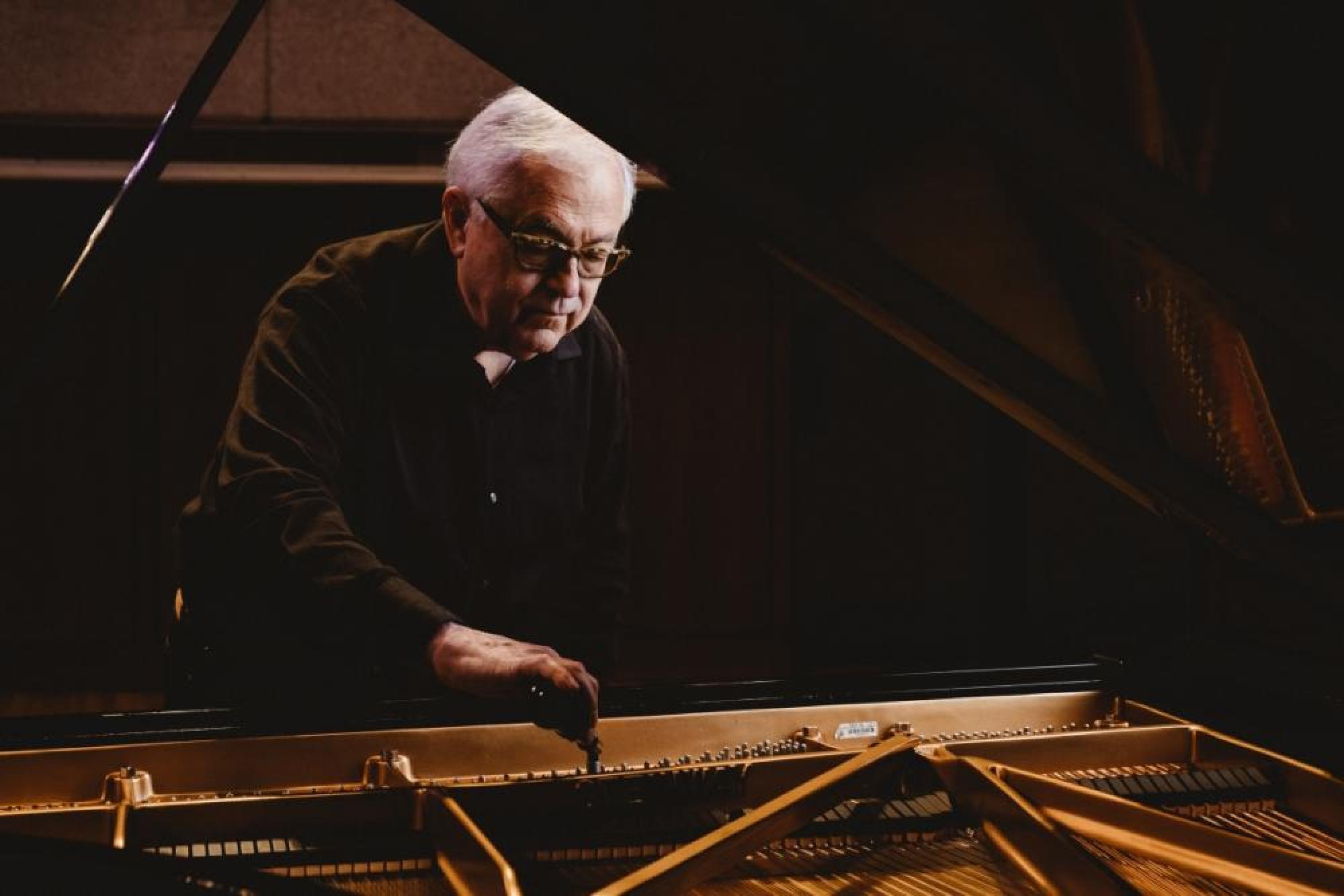 Charles Ball tunes a piano