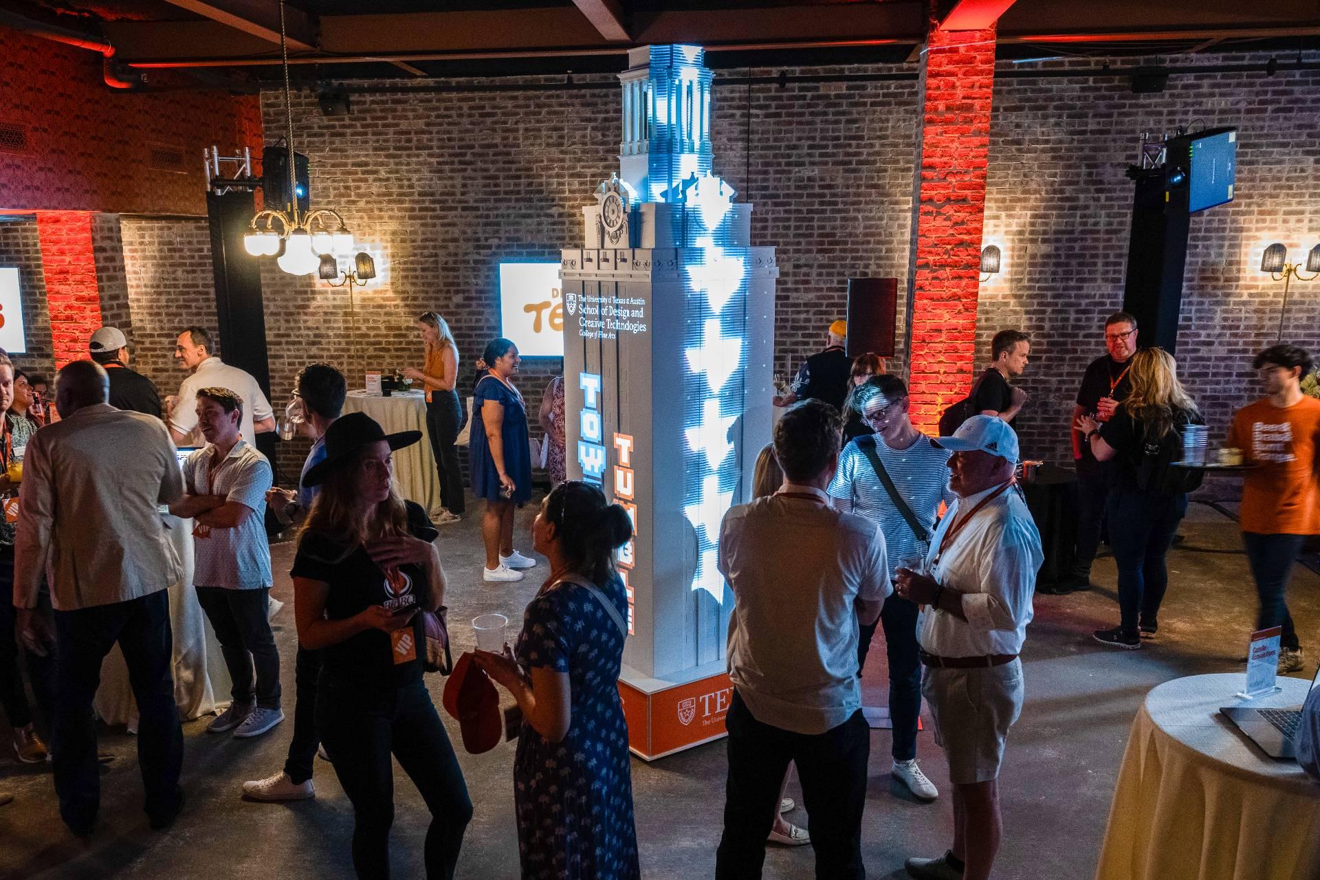 Imagery is projected on a 3D model of the UT Tower at a SXSW event