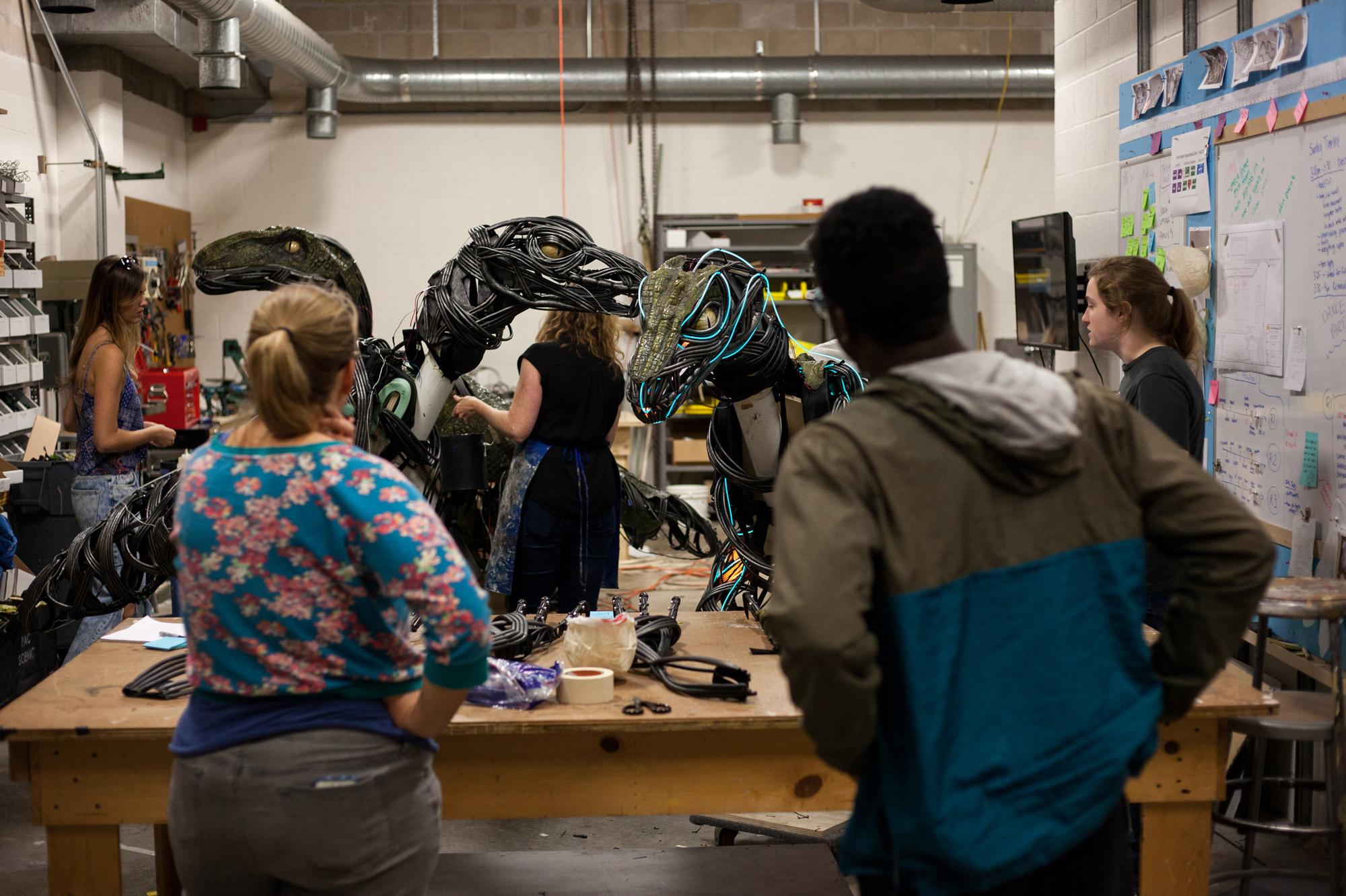 an image of students working on making animatronic raptors in a work shop