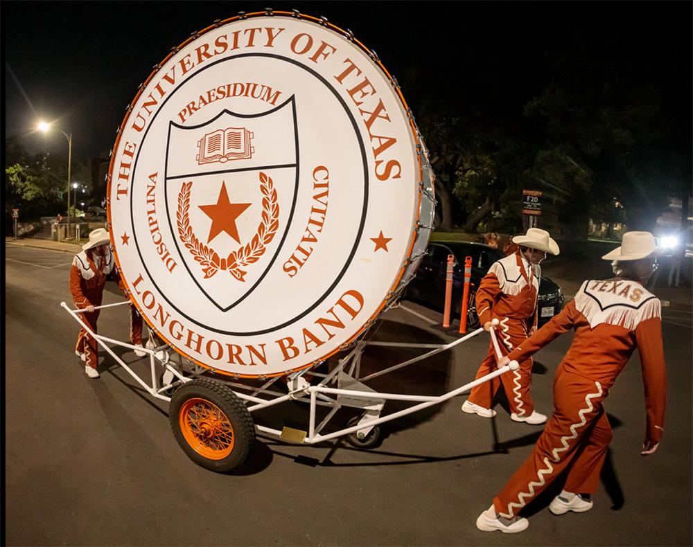 Longhorn Band members pull the "Big Bertha" drum after the Texas-Rice football game, which will be retired from service this fall