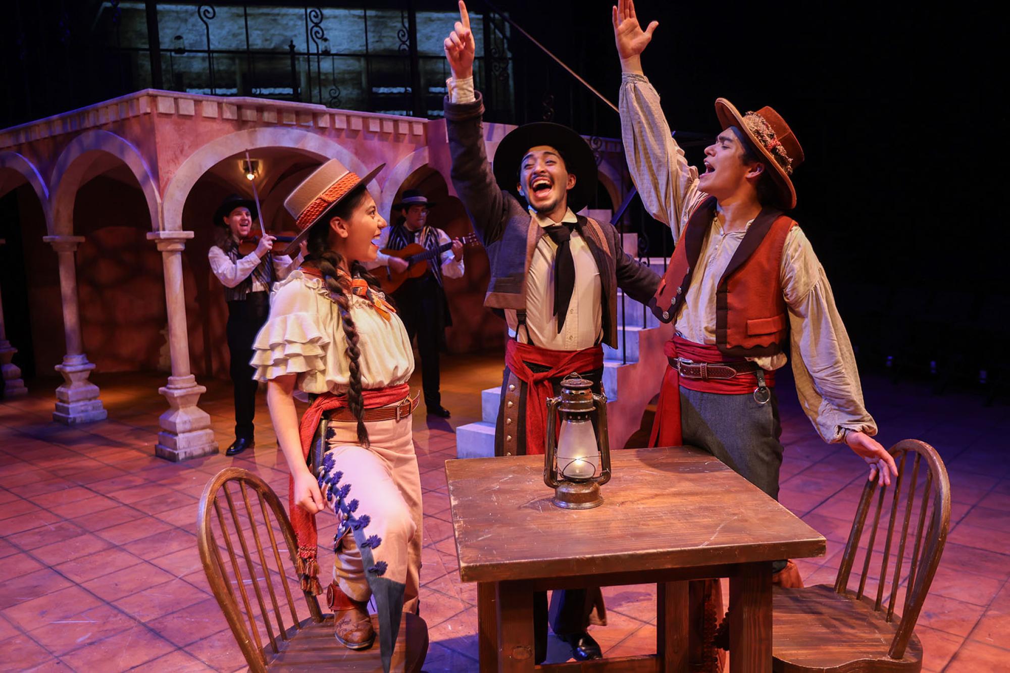 Production still of three students performing in Karen Zacarías' play "Romeo y Juliet"