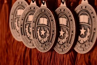 Detail photo of five medallions for UT Honors Day.