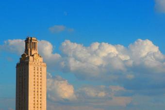 Photo of the UT Tower set against a blue sky with clouds.