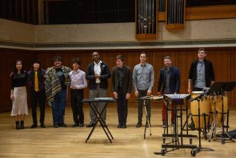 A group of percussion students on a stage