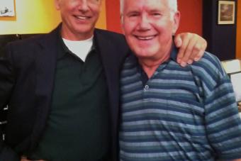 James Walters poses for a photo next to Mark Harmon