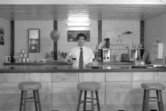 Photo of Michael Smith in his installation Government Approved Home Fallout Shelter Snack Bar