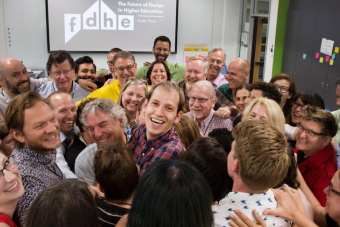 A group of designers gathers for a group hug