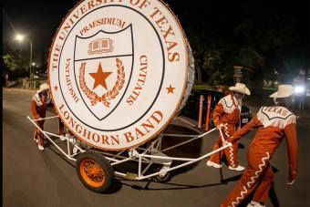 Longhorn Band members pull the "Big Bertha" drum after the Texas-Rice football game, which will be retired from service this fall