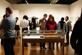 image of people in a gallery looking at a new exhibition