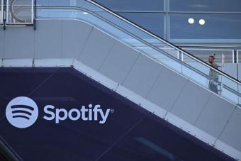 Person going up steps with a Spotify logo on it