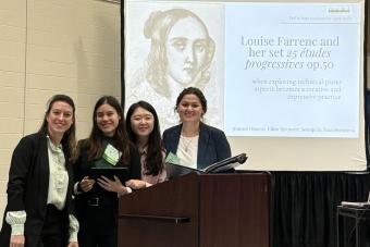 4 students presenting at a conference