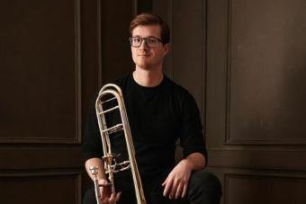 Evan Williams posing with a trombone