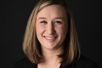 Headshot of Marissa Guarriello with black background