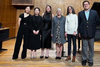 6 people standing on stage