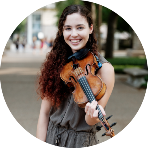 A student holding a violin.