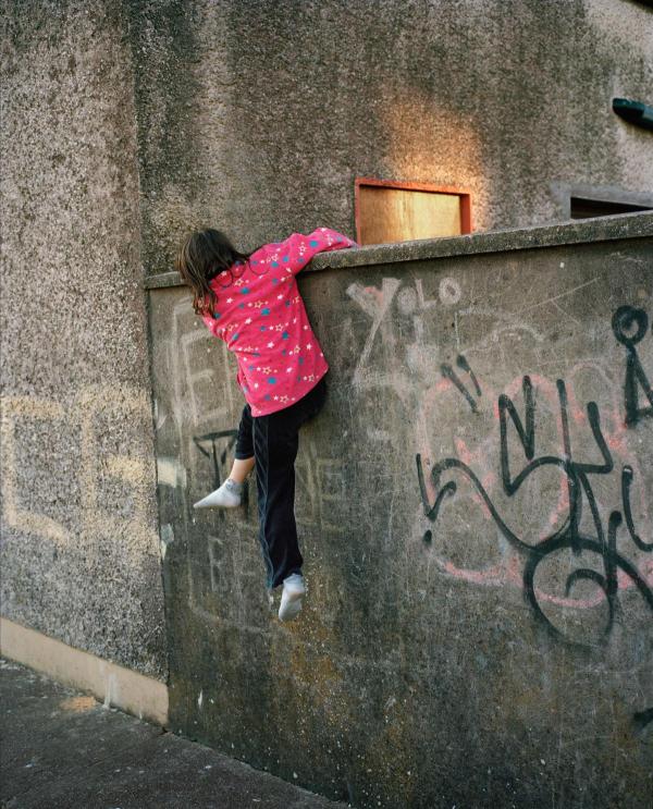 image by Doug Dubois of a girl climbing a wall