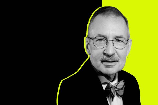 Black and white headshot of organist Gregory Eaton in a bowtie in front of a black and neon lime background.