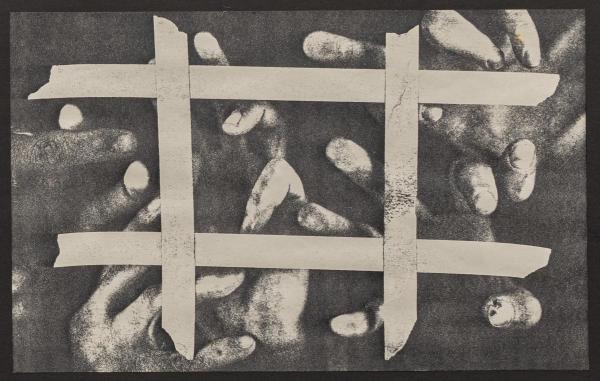 black and white image of fingers pressed against glass