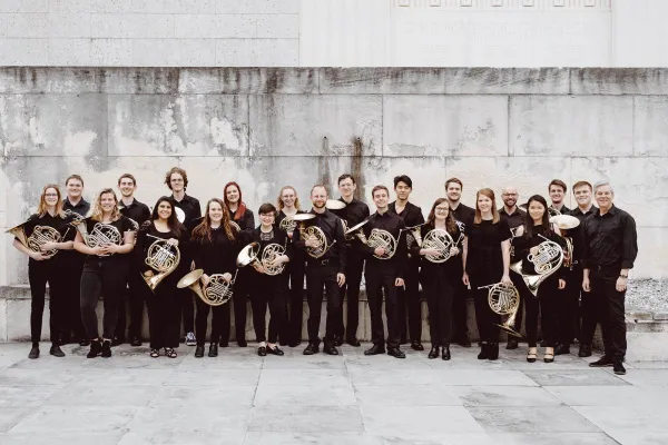 the 2019 horn studio with their horns, in a white stone courtyard.