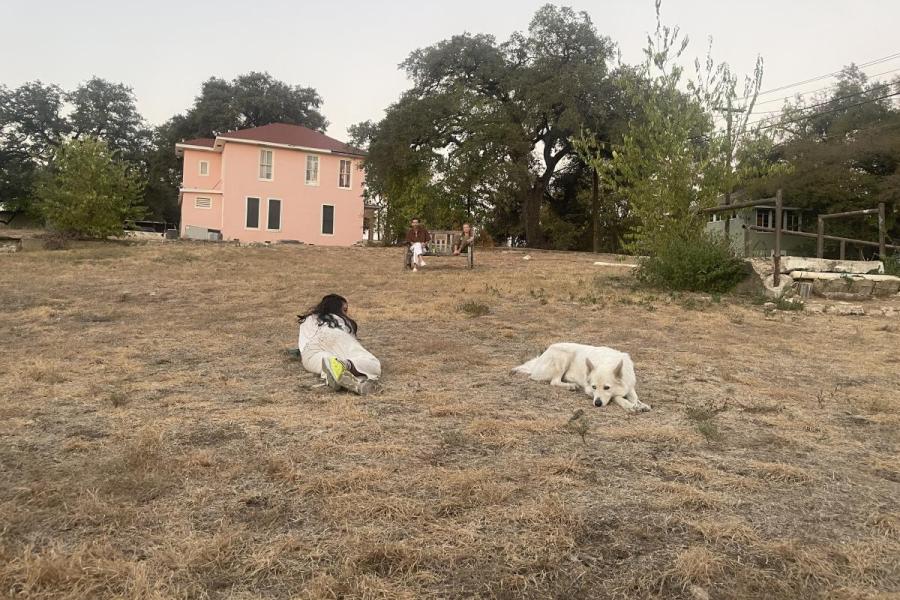 image of a person and their dog laying in a field