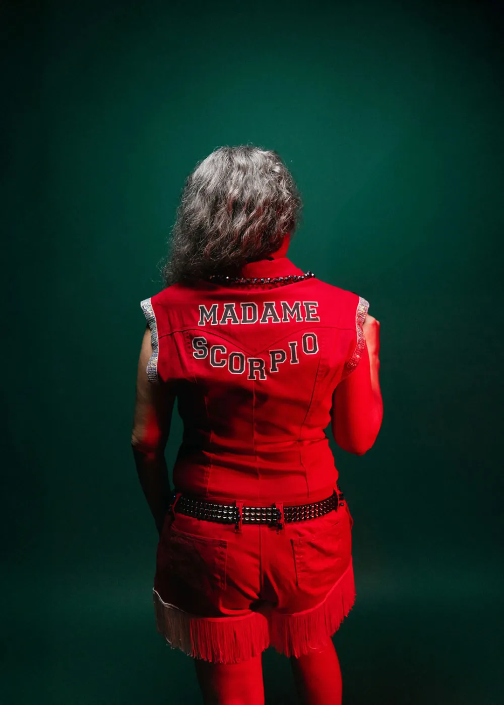 Dianne Whitehair wearing a red jacket with Scorpio Rising on the back