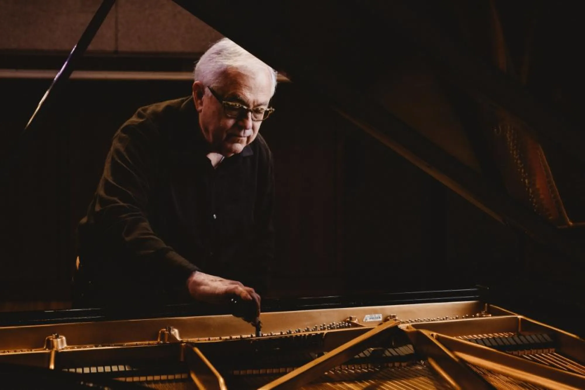 Charles Ball tunes a piano