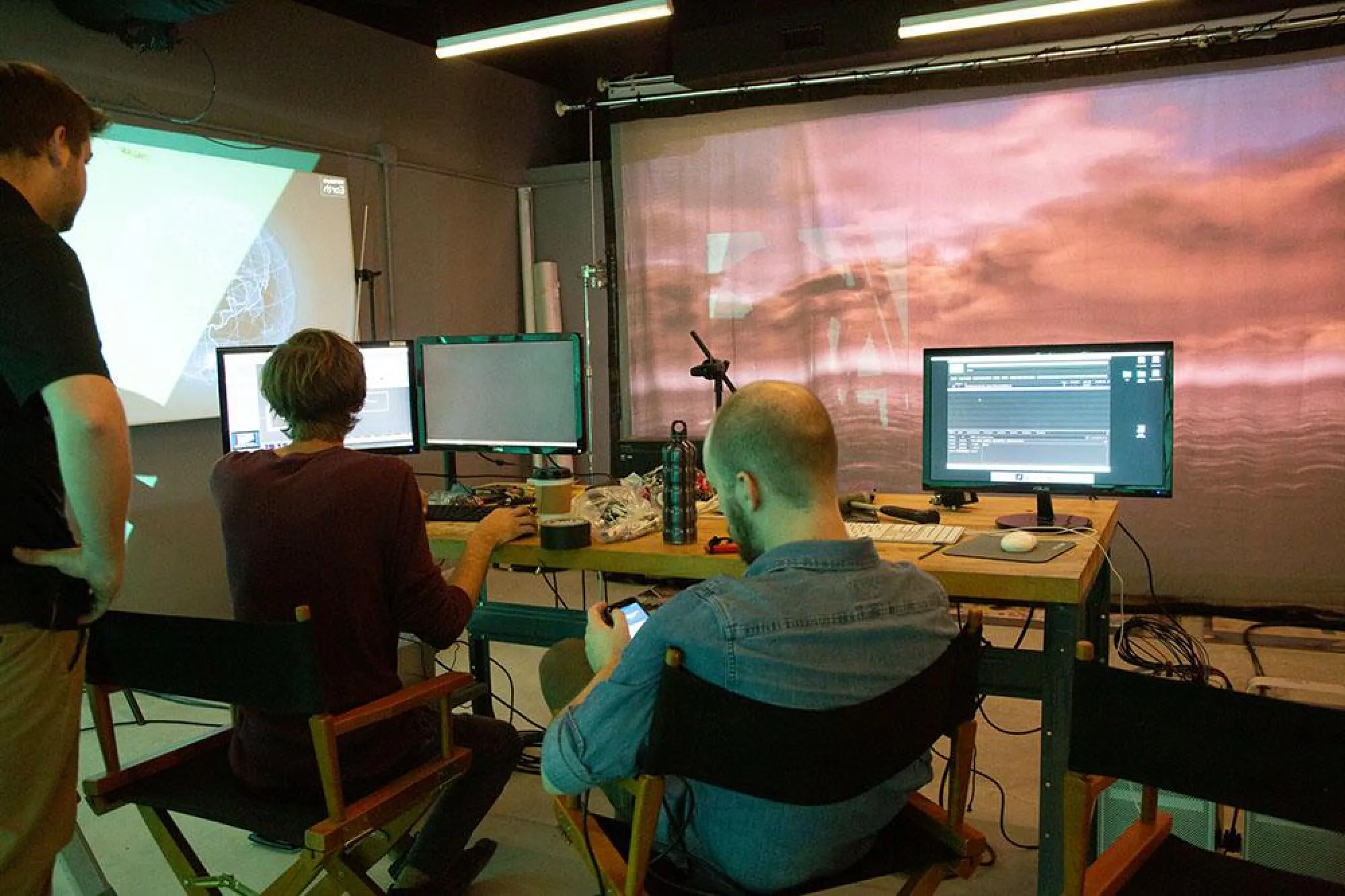 Students operate software outside of the Resilience Sentry escape room to control the projection and other effects in the space during a demo in December 2019.
