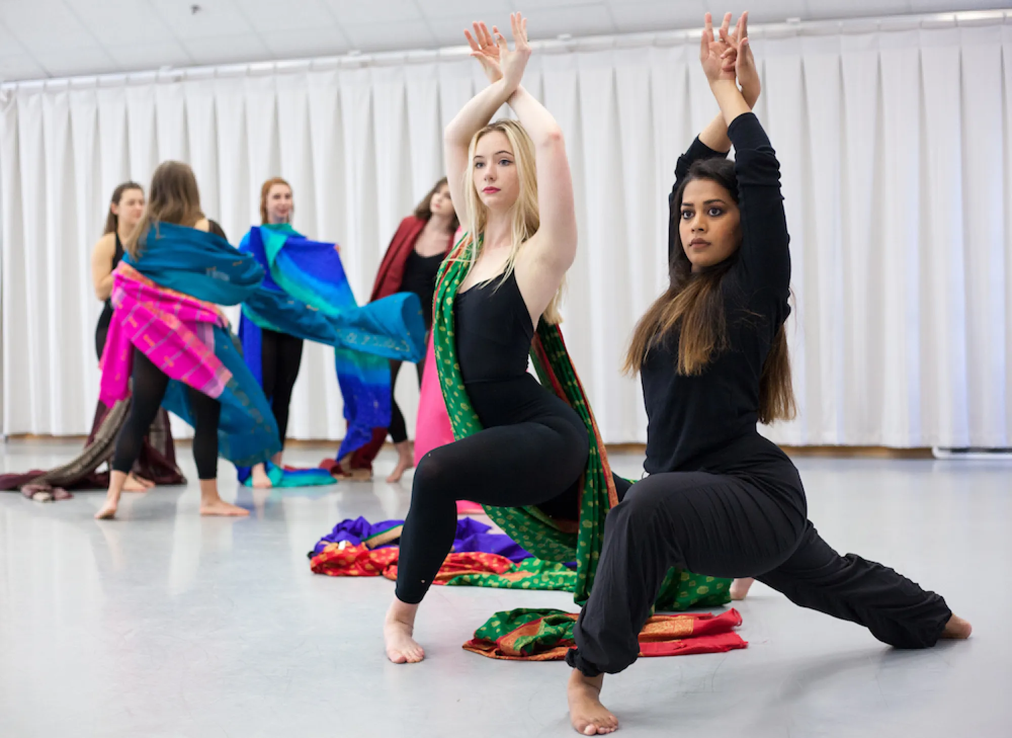 two students rehearse dance moves