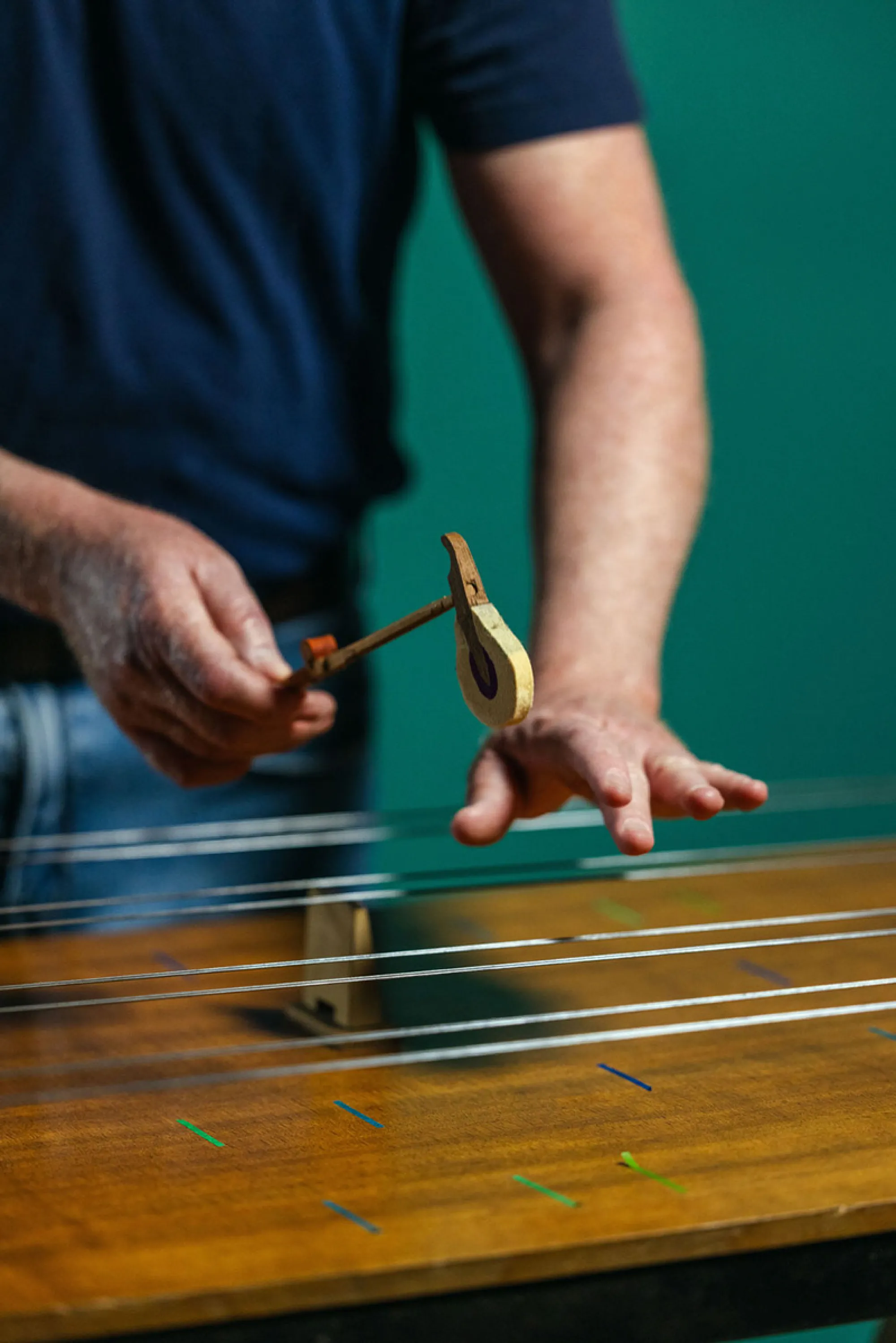 Travis Weller plays an instrument he built