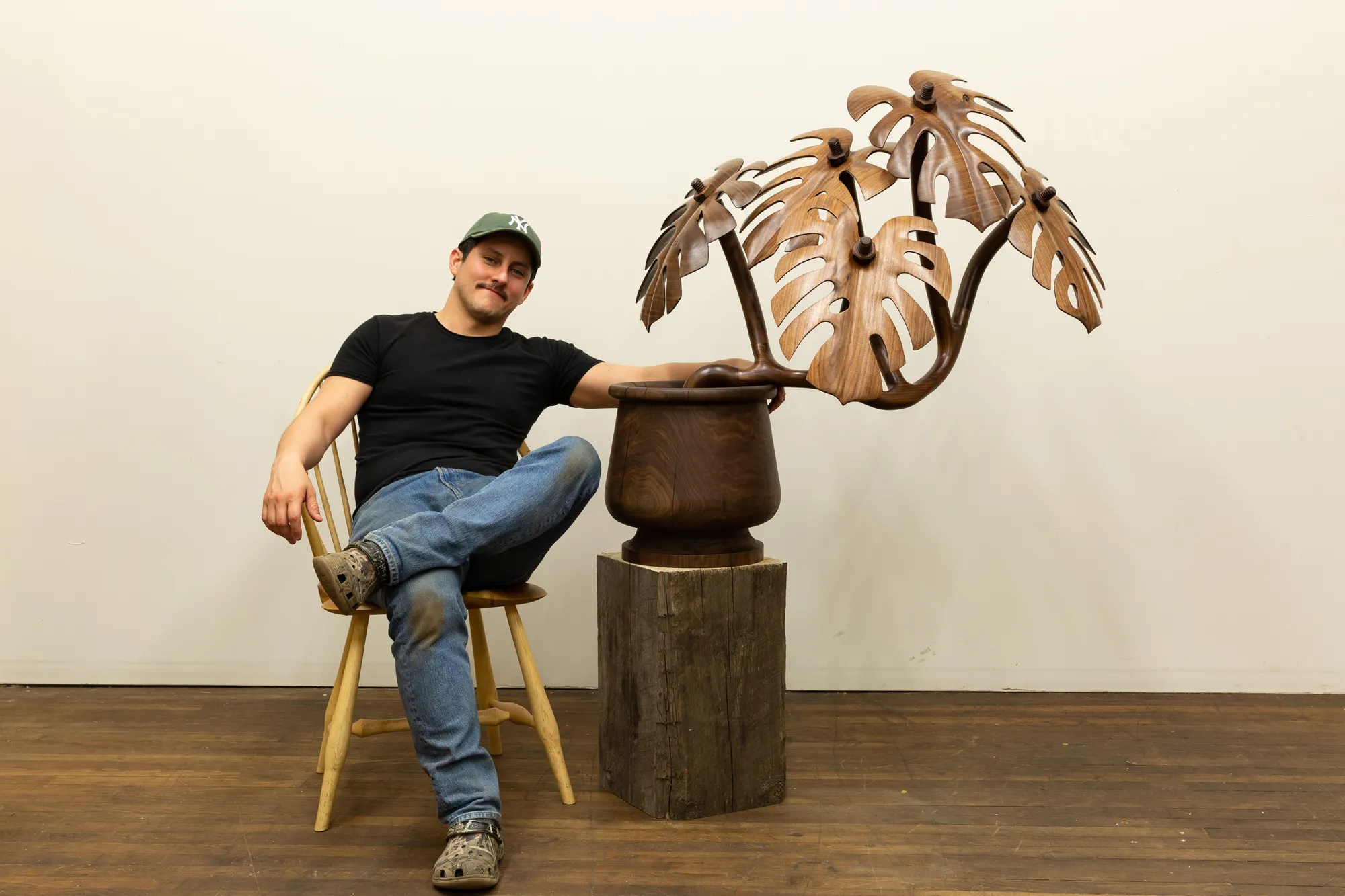 Raul De Lara with wooden botanical sculpture