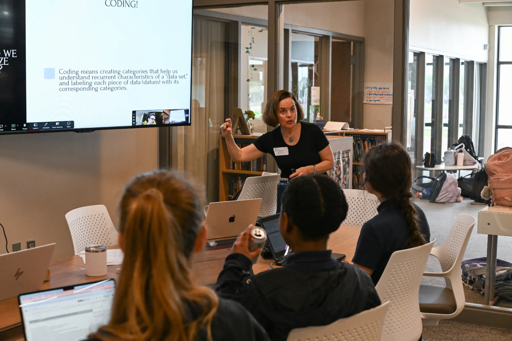 Katie Dawson in front of a classroom of students