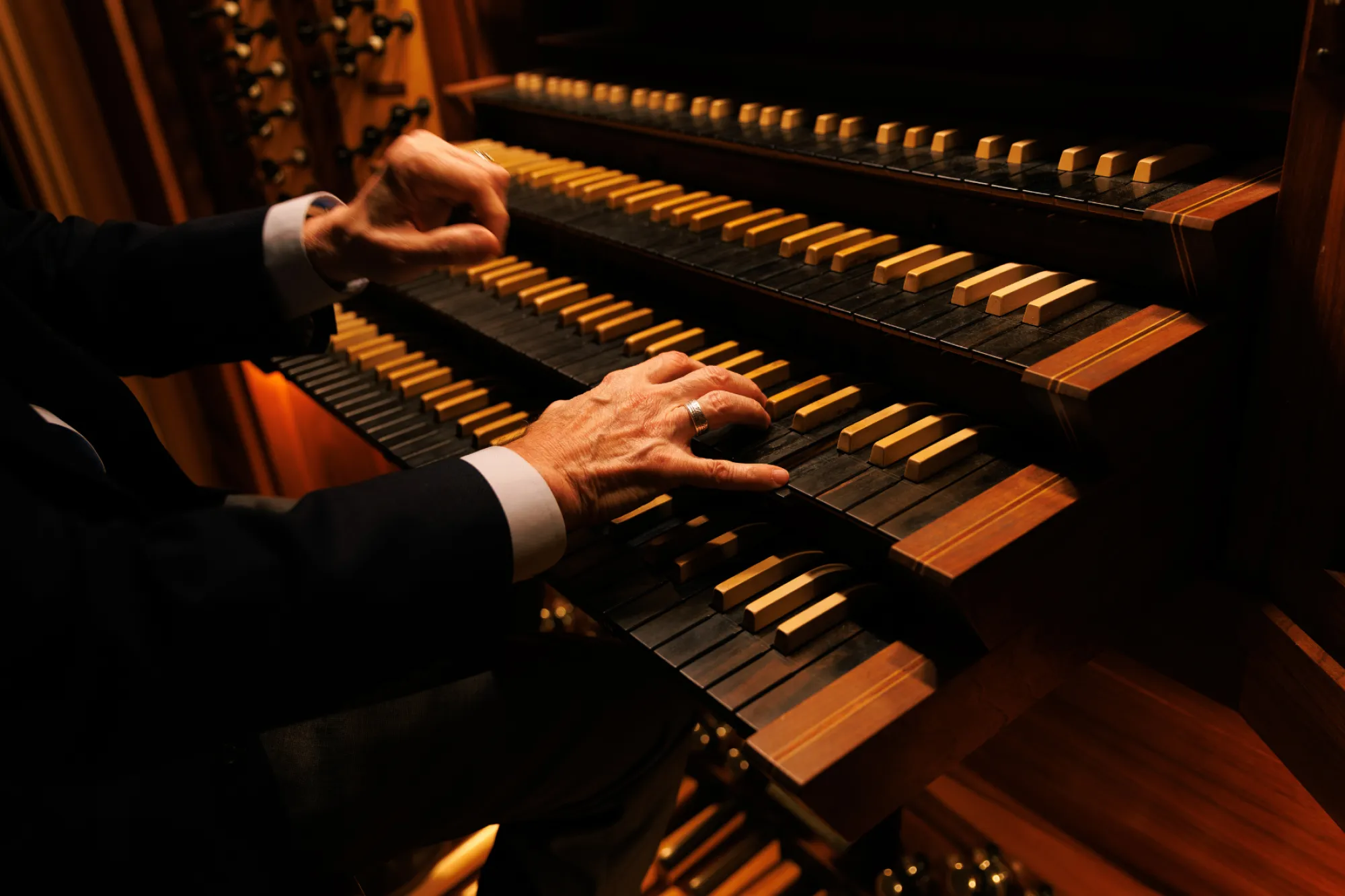 Hands on the keyboard of Bates Organ