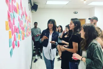 Doreen Lorenzo works with UT students on branding materials for the Center for Integrated Design.