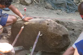 Michael Thomas, left, discovers the inscription on the slab from the Etruscan monument.