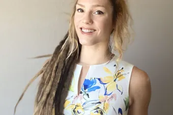 A portrait of a woman with long hair in small braids 
