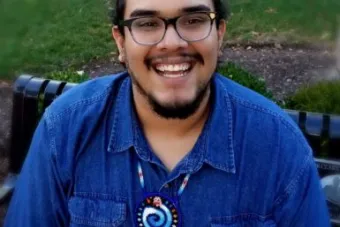 Andrew Valdez wearing a bright blue shirt