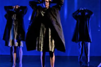 Jacqueline Heard Hinton on a blue-lit stage with other dancers
