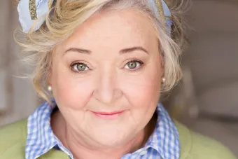A headshot of Rachel Winfree wearing a bow in her hair