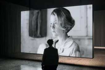 image of person in gallery looking at black and white photo of woman