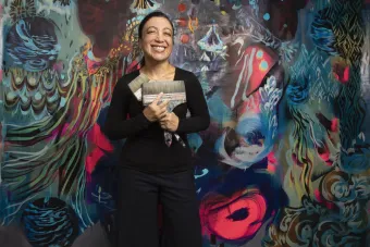 University of Texas at Austin's Studio Professor Scherezade Garcia standing in front of her large scale painting for the Praxis Gallery exhibition.