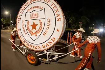 Longhorn Band members pull the "Big Bertha" drum after the Texas-Rice football game, which will be retired from service this fall