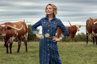 Gay Gaddis posing with longhorns