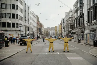 Performers occupying Royal Avenue at the location of a drop arm barrier that permitted buses through the center and secured the space between two checkpoints